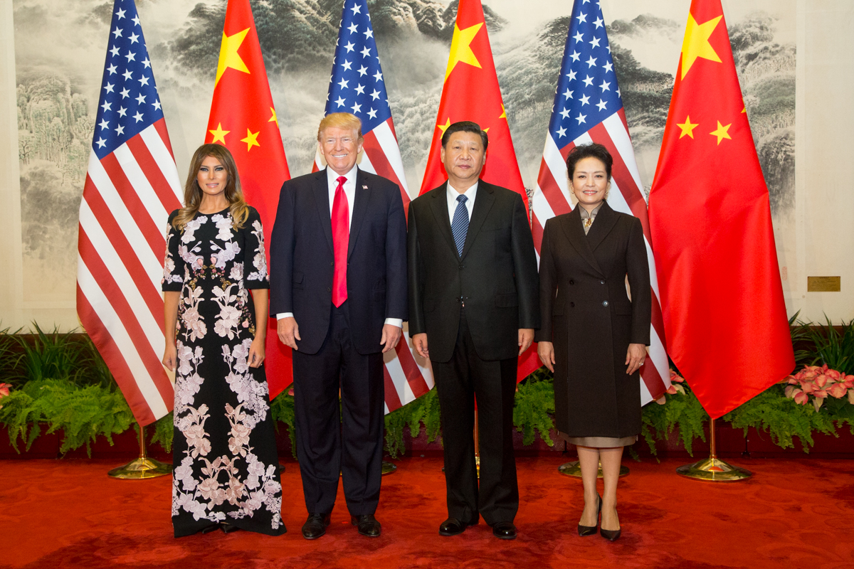 President Trump, Melania Trump, President Xi Jinping and Peng Liyuan posed in front of alternating American and Chinese flags.